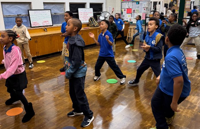  Group of students in Dance class moving and shaking to cool new dance moves. 